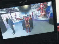  ??  ?? A Star photograph­er tries on Iron Man’s suit using augmented reality at the exhibit, which spans 25,000 square feet.