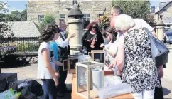  ??  ?? Market traders Logierait pupils set up a promotiona­l stall in Pitlochry