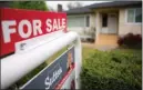  ?? The Canadian Press ?? A real estate sign is posted on a property for sale last month in Vancouver. A website for overseas buyers says Chinese nationals inquired about US$1.45 billion worth of Canadian properties last year.