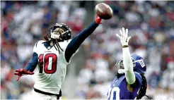  ?? AP Photo/Michael Wyke ?? Q Houston Texans wide receiver DeAndre Hopkins, left, reaches for a pass as New York Giants defensive back Janoris Jenkins defends on Sunday in Houston.