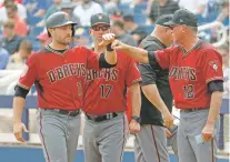  ?? MATT YORK/THE ASSOCIATED PRESS ?? The Diamondbac­ks’ A.J. Pollock, from left, and bench coach Jerry Narron, right, on Thursday during a spring training game in Phoenix. The team has decisions to make about several positions, but manager Torey Lovullo said there is plenty of time to...