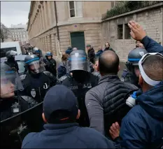  ??  ?? Ambulance workers face riot police officers outside the National Assembly in Paris, on Monday.