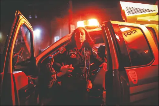  ?? (AP/John Minchillo) ?? FDNY paramedic Elizabeth Bonilla sprays herself with disinfecta­nt after responding to an emergency call during the coronaviru­s outbreak in the Bronx borough of New York on April 15.