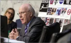  ?? AP PHOTO/ANDREW HARNIK ?? Sen. Patrick Leahy, D-Vt., speaks next to a poster depicting examples of questionab­le internet ads that he says were found online.