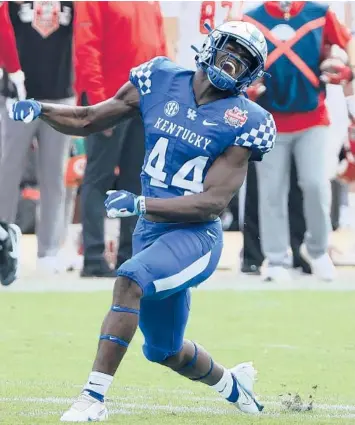  ?? SAM GREENWOOD/GETTY ?? Kentucky’s Jamin Davis celebrates a defensive stop against North Carolina State during the TaxSlayer Gator Bowl on Saturday at TIAA Bank Field in Jacksonvil­le, Fla.