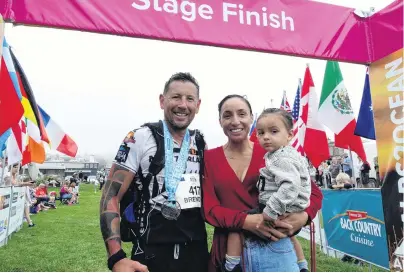  ?? PHOTO: DANIEL BIRCHFIELD ?? Family support . . . Wellington’s Brendan Thompson, the first selfsuppor­ted runner to finish the Alps 2 Ocean Ultra, celebrates with wife Hinano and son Jesse (20 months) at Friendly Bay in Oamaru.