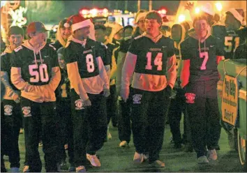  ?? / Kevin Myrick ?? Rockmart’s Kaleb Shelton, Tyler Abrams, Dylan Bailey and C.J. Culver were among players at the front of the team marching in the 2018 Christmas Parade down Marble Street as the grand marshals in honor of their historic 14-0 run to the state title game.