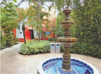  ?? PHOTOS BY PATRICIA HARRIS ?? COLORFUL SIGHTS: Villas at the Occidental Cozumel are designed to look like Mexican haciendas, above. The grounds are dotted with colorful Mexican pottery, right.