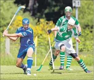  ?? Photo: Neil Paterson ?? Beauly’s Ewen Campbell tries to block the swing of Kilmallie’s Liam Macdonald.