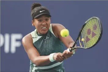  ?? LYNNE SLADKY AP PHOTO/ ?? Naomi Osaka, of Japan, hits a return to Caroline Garcia, of France, during the Miami Open tennis tournament, on March 24 in Miami Gardens, Fla.