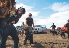  ?? Robyn Beck, AFP/Getty Images ?? A protester is treated after being pepper-sprayed by private security contractor­s with attack dogs on land being graded for the Dakota Access Pipeline oil pipeline, near Cannon Ball, N.D.