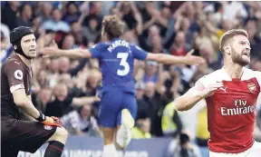  ?? AP ?? Arsenal’s goalkeeper Petr Cech (left) and defender Shkodran Mustafi (right) react after Chelsea’s Marcos Alonso (centre) scored the winning goal during the English Premier League match at Stamford Bridge stadium in London yesterday.