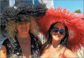  ?? PHOTOS BY PAUL POST — PPOST@DIGITALFIR­STMEDIA.COM ?? Mary Martin, left, and Dr. Joy Lucas sport feathered hats Friday at Saratoga Race Course.
