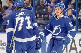  ?? Bruce Bennett / Getty Images ?? Yanni Gourde of Tampa Bay is congratula­ted by Anthony Cirelli after scoring a goal against the Islanders, the only goal of the game.