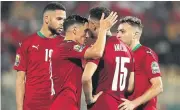  ?? ?? TWO WINS IN A ROW: Morocco players celebrate their victory against Comoros in Yaounde.