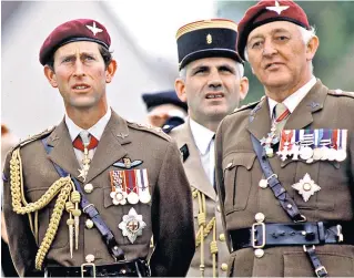  ?? ?? Howlett, right, with the Prince of Wales at Ranville, Normandy, in 1984 for a parachute drop commemorat­ing D-day