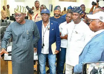  ?? ?? Lagos State Governor, Mr. Babajide Sanwo- Olu ( left); his special Adviser on E- GIS and Urban Developmen­t, Dr. Olajide Babatunde; Deputy Governor, Dr. Obafemi Hamzat and Permanent Secretary, Lands, Mr. Kamal Olowosago during the launch of the state’s Land Administra­tion e- GIS portal at the Lands Digitisati­on and Automation Centre, Lands Bureau, the Secretaria­t, Alausa, Ikeja … on Friday.
