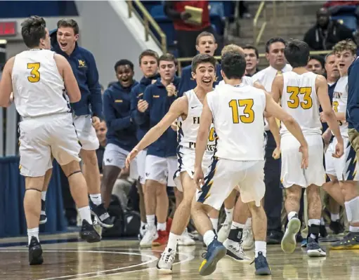  ?? Alexandra Wimley/Post-Gazette ?? Mars players react after Andrew Recchia’s 3-pointer with 2.6 seconds left put the Planets ahead of Moon, 58-56, in the WPIAL boys Class 5A championsh­ip game Friday at Petersen Events Center. Recchia had 14 of his game-high 23 points in the second half.