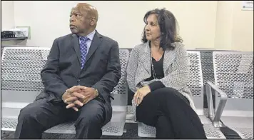  ?? JEREMY REDMON/JREDMON@AJC.COM ?? When federal immigratio­n officials Saturday declined to tell U.S. Rep. John Lewis how many people were being held at the Atlanta airport, Lewis turned to a gathering crowd and said: “Why don’t we just sit down and stay a while?”