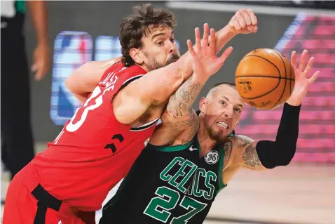  ?? MARK J. TERRILL/ASSOCIATED PRESS ?? The Boston Celtics’ Daniel Theis, right, and the Toronto Raptors’ Marc Gasol battle for a rebound during the second half of a conference semifinal playoff Monday in Lake Buena Vista, Fla.