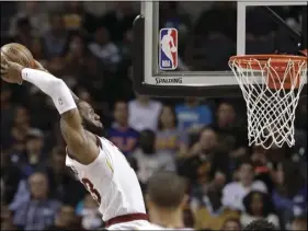  ??  ?? Cleveland Cavaliers’ LeBron James goes up to dunk against the Charlotte Hornets during the first half of an NBA basketball game in Charlotte, N.C., on Wednesday. AP PHOTO/CHUCK BURTON