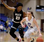  ?? Photo courtesy of JBU Sports Informatio­n ?? John Brown sophomore Maddie Altman handles the ball as Mid-America Christian’s Ossyana Ozoani defends on the play during Thursday’s game at Bill George Arena.