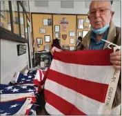  ?? ?? Ted Hester, the oldest veteran present, more than kept up with the younger volunteers sorting and lifting flags.