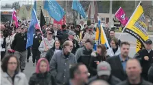  ?? - DAN JANISSE / WINDSOR STAR ?? A group marches on Wyandotte St. E. during last year’s National Day of Mourning ceremony for workers killed or injured in the workplace.