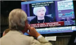  ??  ?? Traders work on the floor of the New York Stock Exchange (NYSE) and monitor Janet Yellen (on screen), Chair of the Board of Governors of the Federal Reserve, as she speaks at a press conference from Washington DC, at the NYSE in New York, New York,...