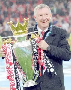  ?? — AFP photo ?? File photo shows Manchester United’s Scottish manager Alex Ferguson holds the Premier League trophy at the end of the English Premier League football match between Manchester United and Swansea City at Old Trafford in Manchester, northwest England.