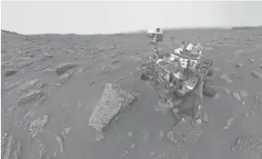  ?? AP ?? A composite image made from a series of June 15, 2018, photos shows a self-portrait of NASA’s Curiosity Mars rover in the Gale Crater. The rover’s arm, which held the camera, was positioned out of each of the dozens of shots which make up the mosaic. A dust storm has reduced sunlight and visibility at the rover’s location.