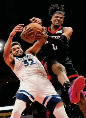  ?? Eric Christian Smith/Associated Press ?? Rockets guard Jalen Green battles Timberwolv­es center Karl-Anthony Towns for a rebound. Towns led Minnesota with 25 points, while Green paced the Rockets with 21.
