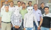  ?? SOURCED ?? The accused, Amir and Uvais (in masks), in police custody. They were arrested from Yamuna Vihar in northeast Delhi.