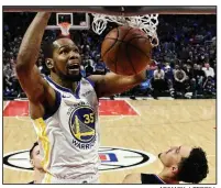  ?? AP/MARK J. TERRILL ?? Golden State Warriors
forward Kevin Durant dunks as Los Angeles Clippers guard Landry Shamet defends during the second half of Game 4 of a first-round playoff series Sunday in Los Angeles. Durant had 33 points, 7 rebounds and 6 assists as the Warriors won 113-105 to take a 3-1 series lead.