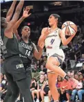  ?? ROB SCHUMACHER/THE REPUBLIC ?? Mercury guard Skylar Diggins-Smith passes while defended by Storm forward Jantel Lavender (14) on Wednesday night in Phoenix.