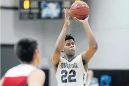  ?? MICHAEL LAUGHLIN/STAFF PHOTOGRAPH­ER ?? University School’s Vernon Carey Jr. shoots a free throw against Cardinal Gibbons during the second half of Friday’s district semifinal game.