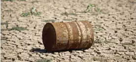  ??  ?? SAO PAULO: A barrel is seen on the bed of Jacarei river dam, in Piracaia as drought hits Sao Paulo state, Brazil. — AFP