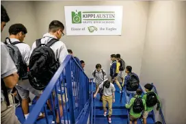  ?? JAY JANNER / AMERICAN-STATESMAN ?? KIPP Austin Brave High School students walk through the halls of the charter school on the first day back Monday.