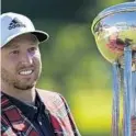  ?? DAVID J. PHILLIP/AP ?? FSU alum Daniel Berger poses with the championsh­ip trophy after winning the Charles Schwab Challenge tournament after a playoff round at the Colonial Country Club in Fort Worth on Sunday.