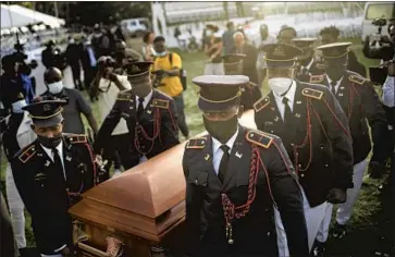  ?? Matias Delacroix Associated Press ?? POLICE CARRY the coffin of slain Haitian President Jovenel Moise at his funeral in Cap-Haitien early Friday. Before the funeral, cries of “Assassin!” filled the air with the arrival of National Police Chief León Charles.