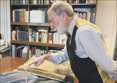  ??  ?? EXPERT HANDS: Chris Webb, Keeper of Archives at the University of York’s Borthwick Institute, examines the parish register.