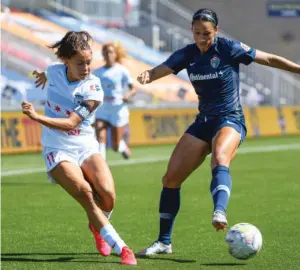  ?? GETTY IMAGES ?? The Red Stars’ Sarah Gorden (left) passes around the Courage’s Lynn Williams.