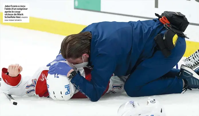  ?? PHOTO USA TODAY SPORTS ?? Jake Evans a reçu l’aide d’un soigneur après le coup vicieux de Mark Scheifele hier.