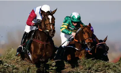  ?? Photograph: Alan Crowhurst/Getty ?? One For Arthur clears the last just ahead of Cause Of Causes