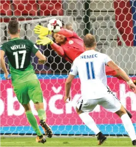  ??  ?? Slovenia’s goalkeeper Jan Oblak makes a save, with Slovakia's Adam Nemec, front right, with Slovenia 's Miha Mevlja, left. Photo: AP