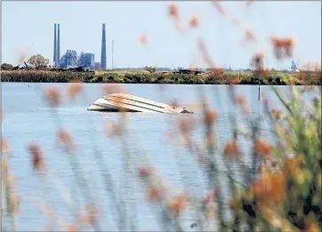  ?? ARIC CRABB — STAFF PHOTOGRAPH­ER ?? A capsized boat remains in the waters of the Delta in Contra Costa County. Abandoned vessels are spread throughout the Delta, and the Contra Costa County Sheriff’s Office hopes that passage of AB 2441 will help provide money to remove vessels from the...