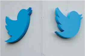  ?? AP PHOTO/JEFF CHIU ?? Twitter logos adorn the company’s offices in San Francisco in 2022.