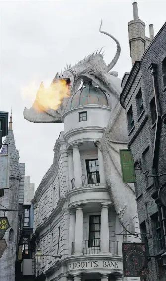  ?? PHOTOS: JOHN RAOUX/ THE ASSOCIATED PRESS ?? A mechanical dragon breathes fire from atop Gringotts Bank on Diagon Alley at the Wizarding World of Harry Potter at the Universal Orlando Resort in Florida. It’s a perfect spot for Facebook and Instagram photos.