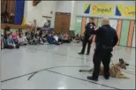  ?? KRISTI GARABRANDT — THE NEWS-HERALD ?? Willowick police officers Don Slapknicke­r and Brian O’Toole answer questions from the fifth grade students in Royalview Elementary School’s D.A.R.E. Program following a K-9 demonstrat­ion.