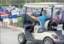  ?? JOHN RAOUX / AP ?? Supporters cheer and wave signs as voters arrive at the Sumter County Elections office drop off their ballots after taking part in a parade of over 300 golf carts supporting Democratic presidenti­al candidate former
Vice President Joe Biden Wednesday in The Villages, Fla.